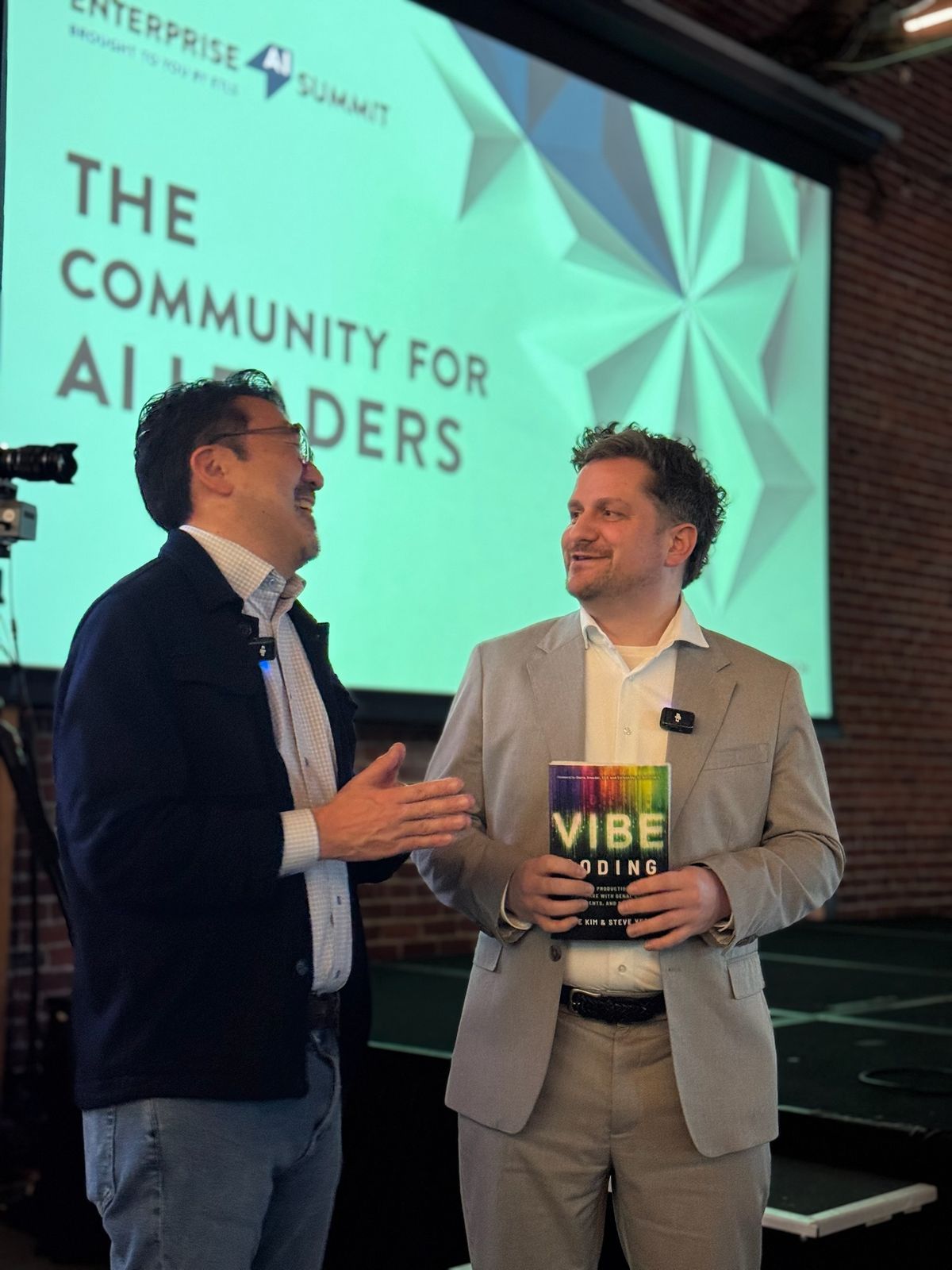 Two men talking at the Enterprise AI Summit